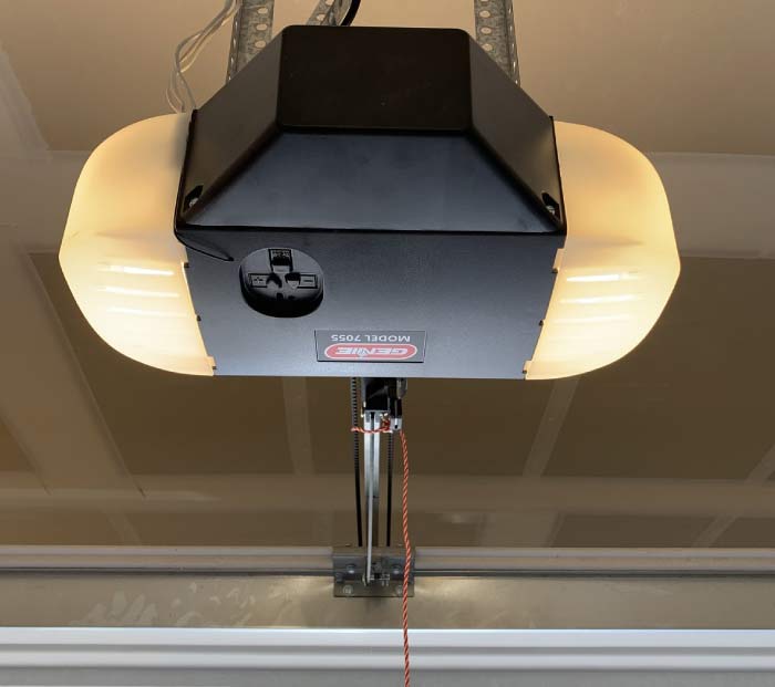 Professional installing a new, quiet garage door opener for seamless home access.