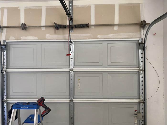 image after of a broken garage door spring, now expertly replaced and functioning.